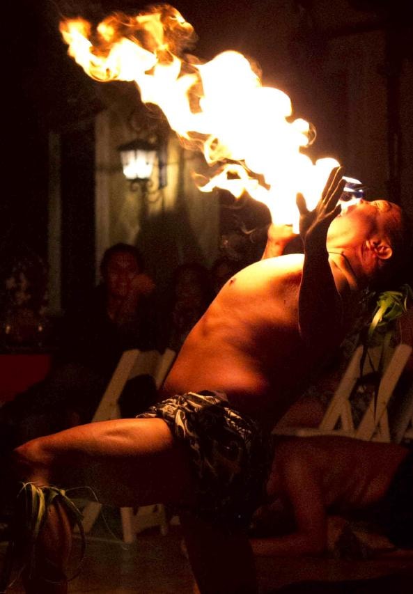 Manea Events fire performer breathing fire at a San Diego luau show